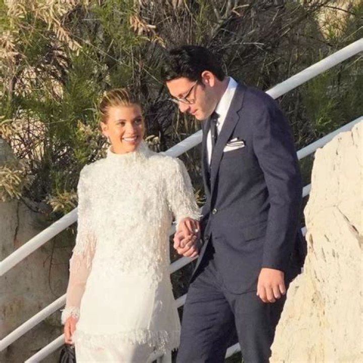 Blushing bride Sofia Richie looks radiant in an elegant white gown as she celebrates her lavish wedding weekend in the French Riviera. The model and daughter of legendary crooner Lionel Richie stepped out with her British fiance Elliot Grainge on Friday evening during their ultra glamorous trip to tie the knot in Antibes. It was unclear whether the happy couple were heading off to a fancy rehearsal dinner, or were dressed up for the nuptials. The stylish 24-year-old chose a demure, delicately beaded floor length ensemble for the occasion paired with white stilettos and wore her long hair in a chic up do. Her record executive groom, 30, looked dapper in a dark suit and tie as they were snapped by their team of photographers at their swanky hotel at sunset. Among the slew of A-list guests jetting in to watch them exchange vows are Cameron Diaz and Benji Madden, Sofia&rsquo;s sister Nicole Richie and husband Joel Madden, as well as her father Lionel Richie and brother Miles. 21 Apr 2023 Pictured: Sofia Richie , Elliot Grainge. Photo credit: EliotPress / MEGA TheMegaAgency.com +1 888 505 6342 (Mega Agency TagID: MEGA971732_001.jpg) [Photo via Mega Agency]
