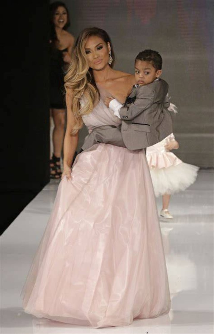 Daphne Joy carrying her son, Sire Jackson