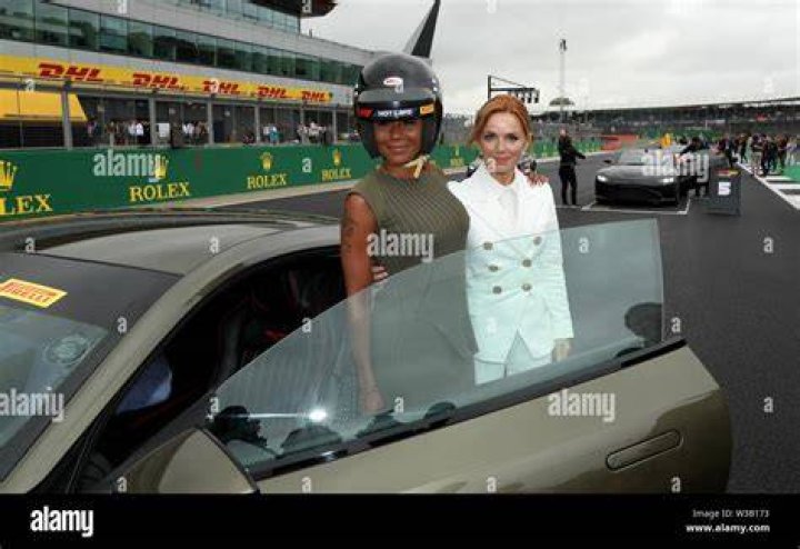 Mel B and Geri Horner hug while singing on the Spice Girls Reunion Tour